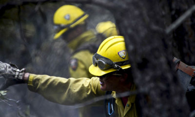 Picture of Vandenberg Air Force Base Hot Shot fire fighter Marissa Halbeisen cutting and clearing a fire line on June 28, 2012 in the Mount Saint Francois area of Colorado Springs.