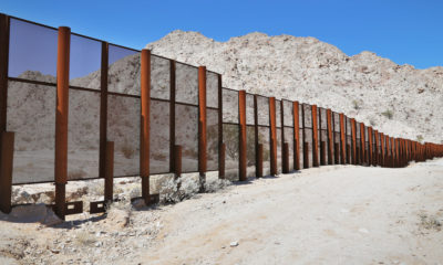 Photo of steel fence protecting the border between Mexico and the United States at the Tinajas Altas Mountains in Arizona.