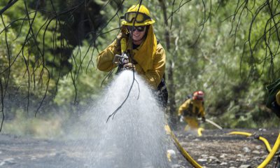 AP photo of fire crews watering down vegetation on Cache Creek Road