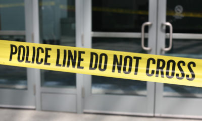 Photo of crime scene tape across plate-glass doors