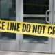 Photo of crime scene tape across plate-glass doors
