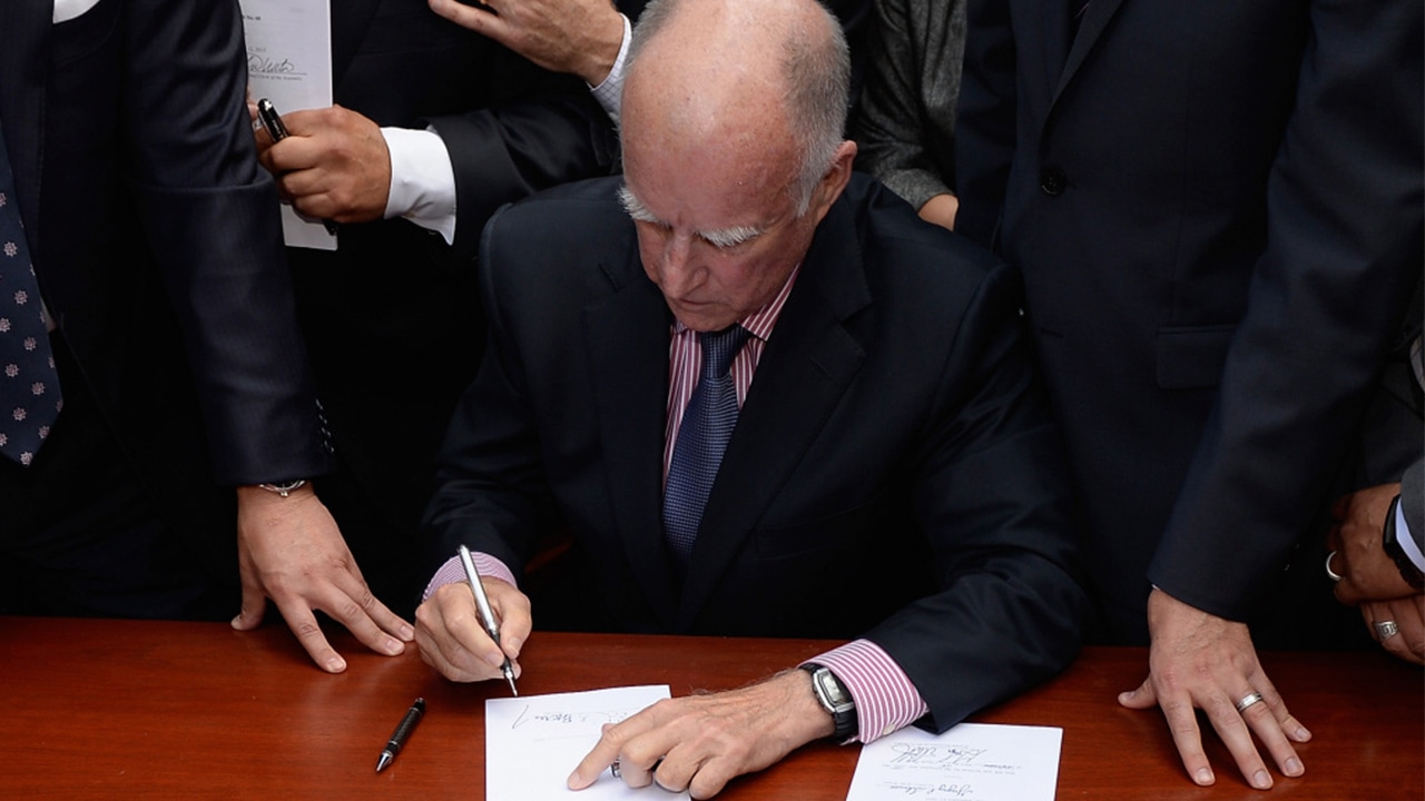 Photo of Jerry Brown signing another bill
