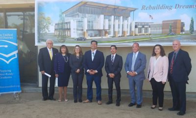 Photo of Fresno area politicians in front of architect's rendering of the "Urban Academy"