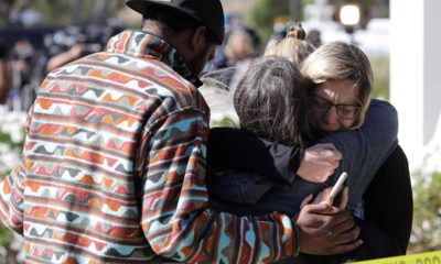Photo of mourners embracing out side of the Thousand Oaks Teen Center