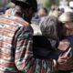 Photo of mourners embracing out side of the Thousand Oaks Teen Center