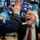 Photo of Wall Street floor traders exchanging high-fives