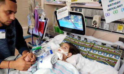 Photo of Ali Hassan with his dying 2-year-old son Abdullah