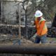 Photo of PG&E employee replacing power poles damaged by a wildfire