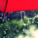 Photo of red umbrella and rain