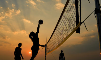 Photo of women playing beach volleyball