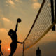 Photo of women playing beach volleyball