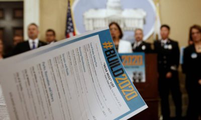 Photo of a reporter looking over a list of local government projects