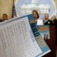Photo of a reporter looking over a list of local government projects