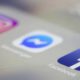 Photo of Facebook, Messenger, and Instagram apps displayed on an iPhone