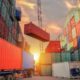 Photo of industrial crane loading container to truck