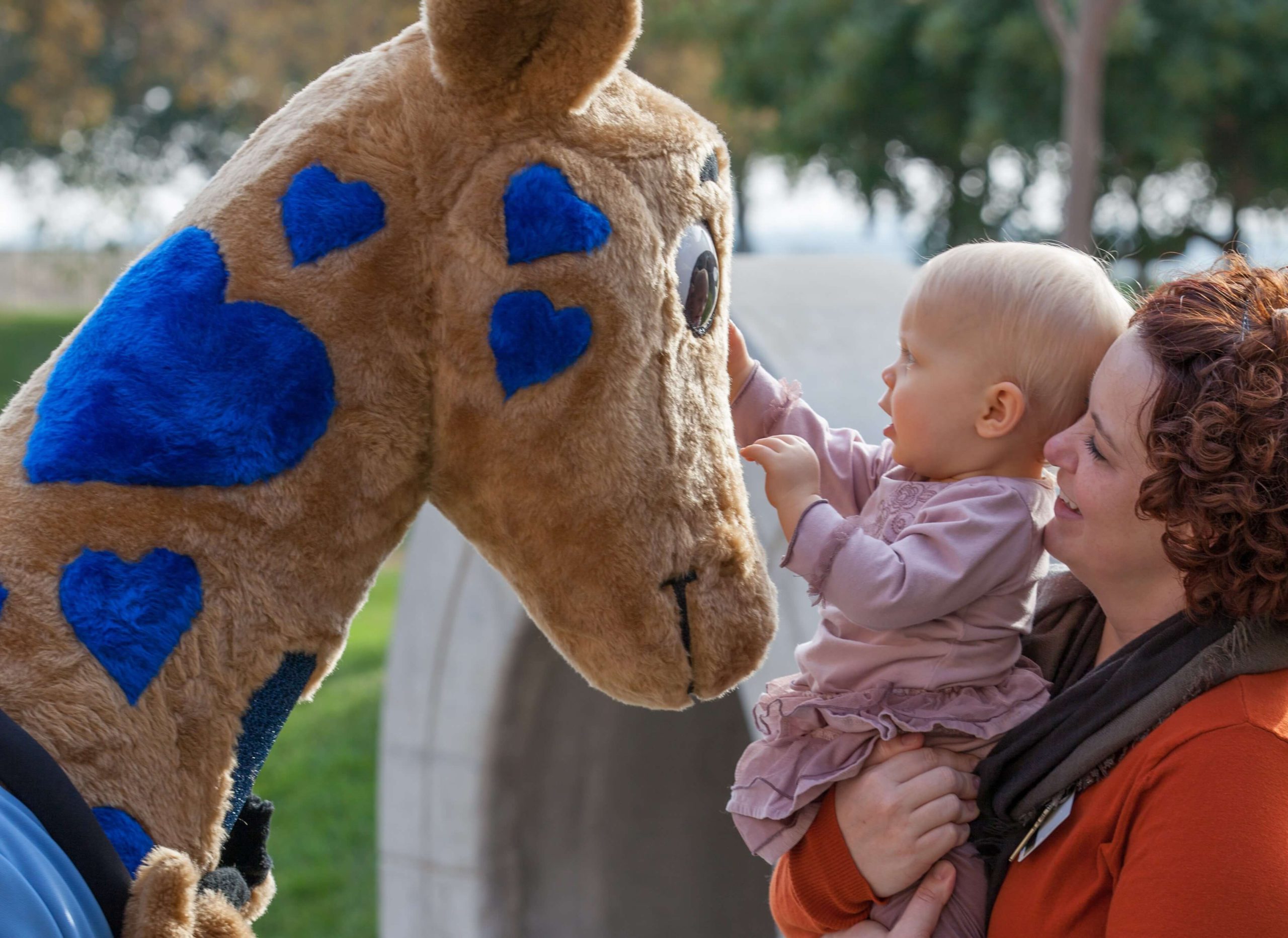Photo of Valley Children's Hospital mascot George the giraffe and a patient