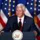 Photo of VP Mike Pence in front of American flags