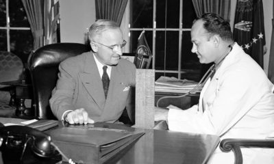 Photo of Brigadier Gen. Wallace Harry Graham, right, personal physician of President Harry S. Truman checking his blood pressure