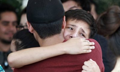 Photo of youths comforting each other at a funeral