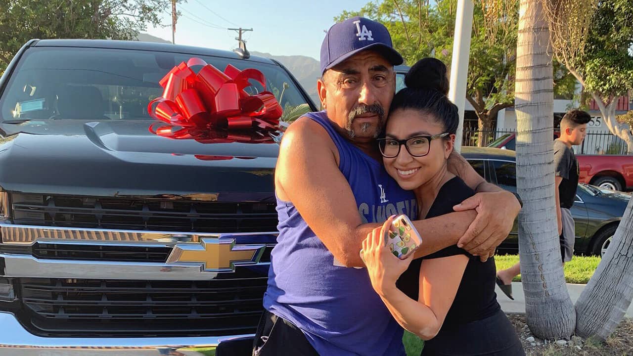Photo of Yesenia Valencia and her dad after she surprised him with a new truck