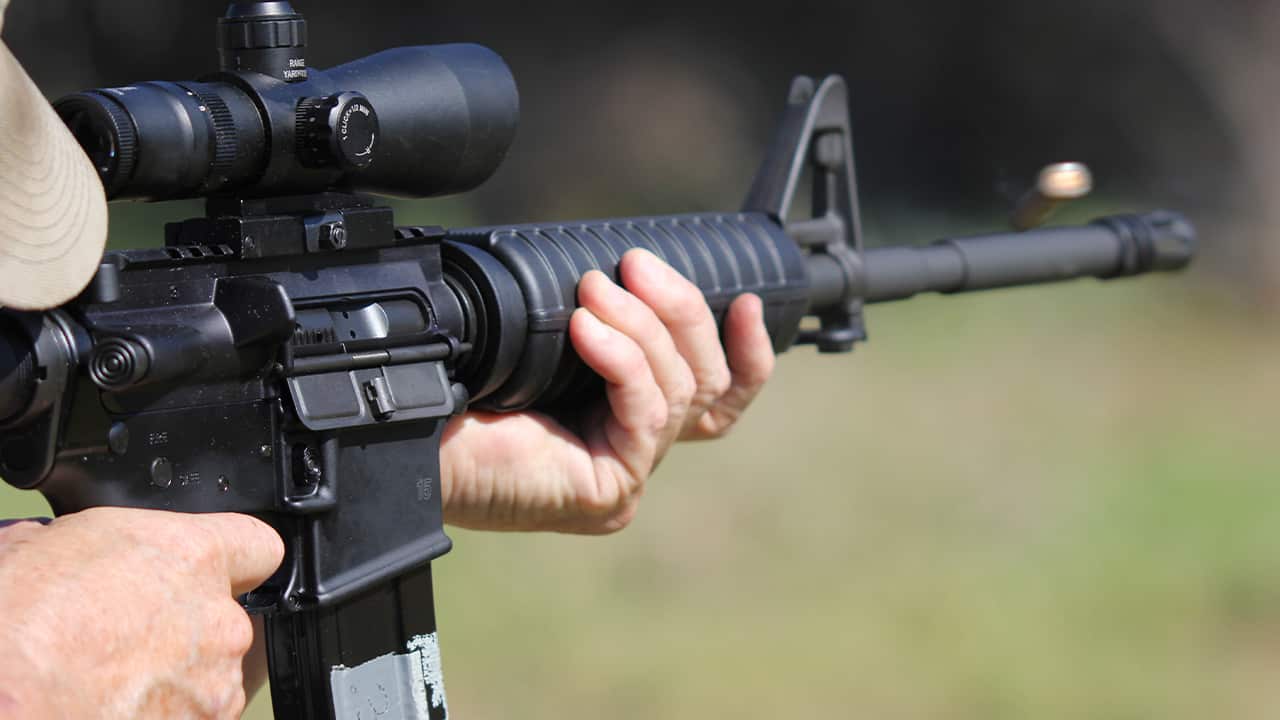 Photo of a man firing a machine gun