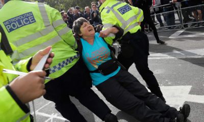 Photo of police arresting a climate demonstrator