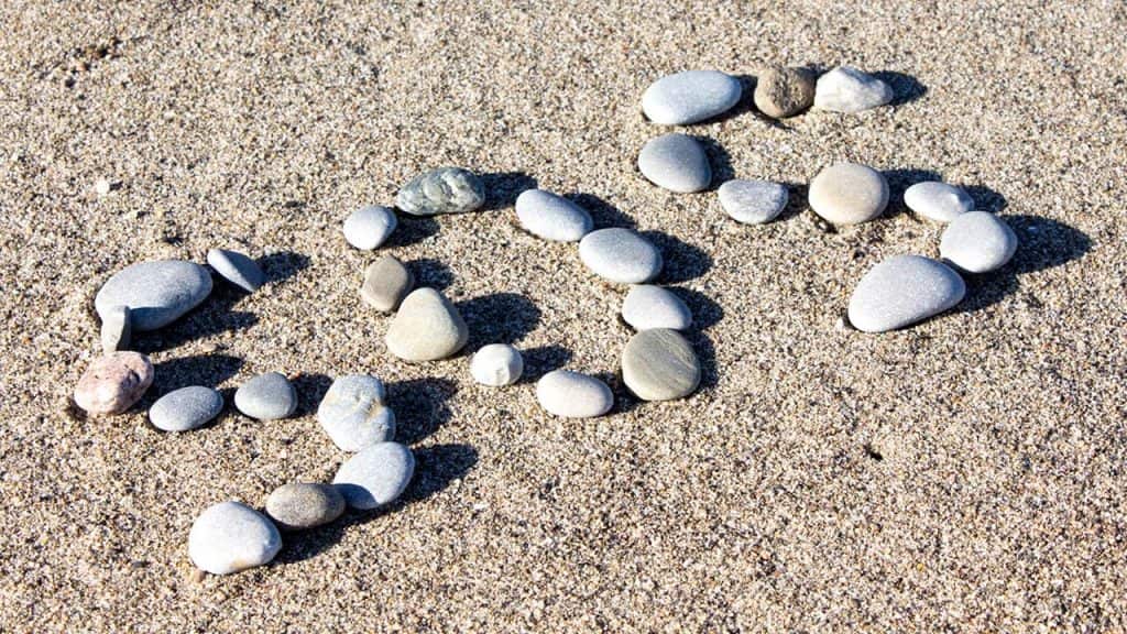 Photo of SOS spelled in rocks
