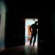 Photo of Honduran father standing at his home