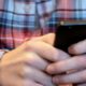 Photo of a person texting on their cellphone