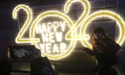 Photo of a woman posing next to a 2020 sign for a photo