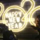Photo of a woman posing next to a 2020 sign for a photo