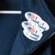 Photo of a jacket with multiple "I Voted" stickers