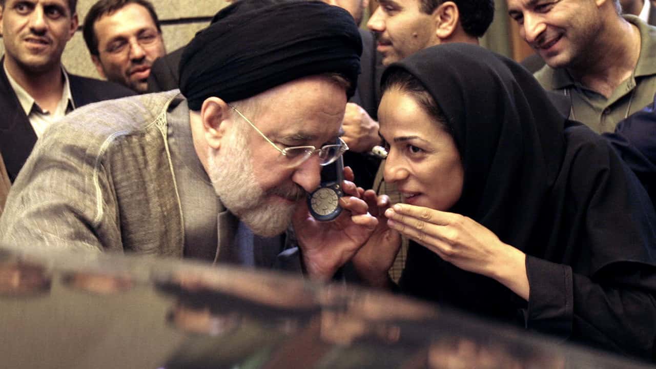 Photo of outgoing reformist Iranian President Mohammad Khatami talking on the phone