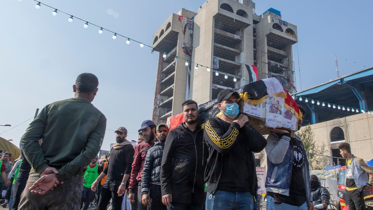Photo of mourners carry the body of their fellow protestor