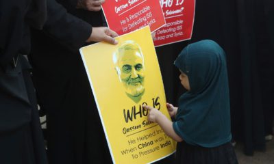 Photo of an Indian Shiite Muslim girl points at a portrait of Iranian Gen. Qassem Soleimani