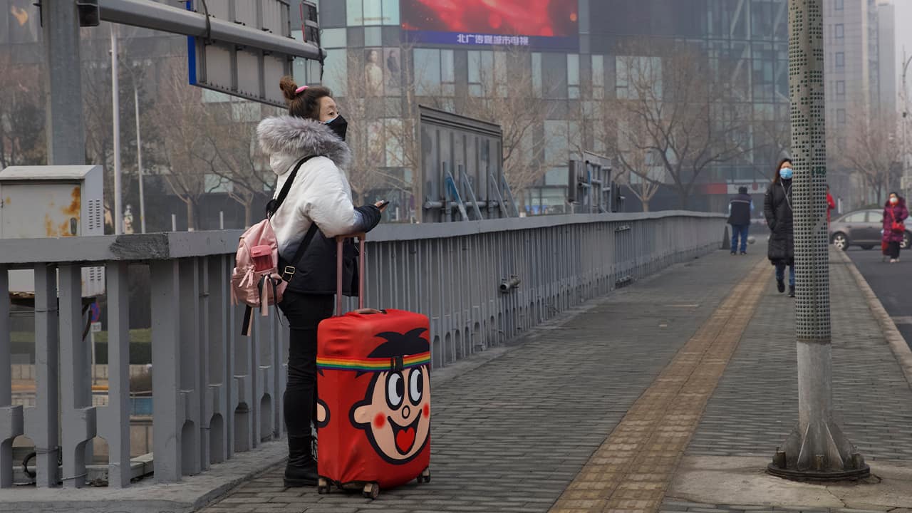 Photo of a traveler standing on a bridge in Beijing