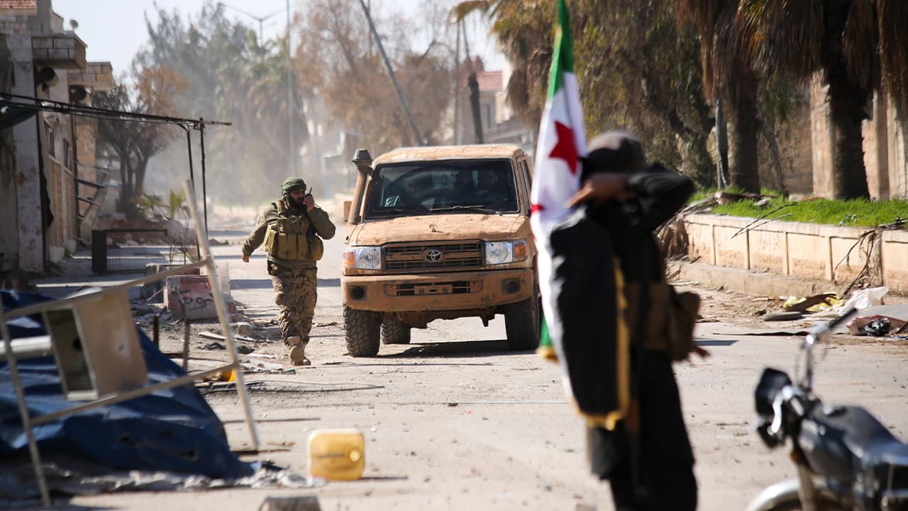 Photo of Syrian rebels entering the town of Saraqeb, in Idlib province, Syria