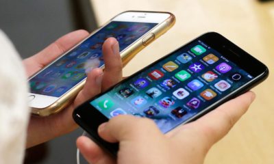 Photo of a customer comparing two iPhones