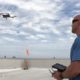 Photo of a drone and its operator
