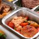 Photo of different types of food in aluminum catering containers