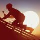 photo of a roofer working under the early evening sun