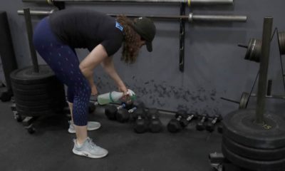 Photo of a woman cleaning weights