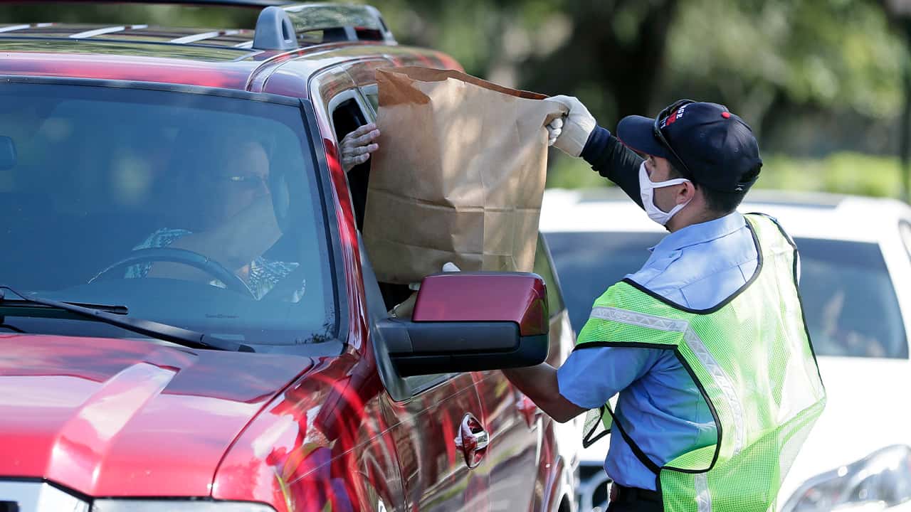 Photo of a fire rescue worker passing out PPE