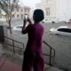 Photo of a woman taking photos of the flooding